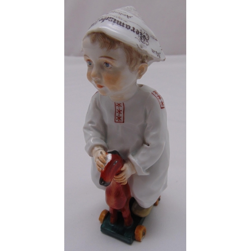 170 - A Meissen figurine of a child on a rocking horse, marks to the base, 17cm (h), A/F