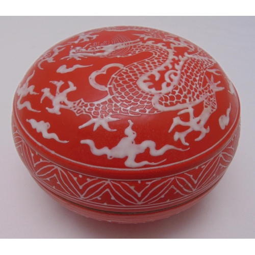 A Chinese porcelain circular temple box with pull off cover, red ground ...