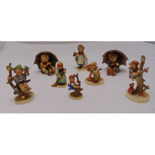 154 - Eight Goebel figurines of children in various pursuits on raised oval bases, marks to the bases