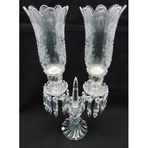 165 - Baccarat a two branch candelabrum with crystal drops and storm lantern shades on fluted circular bas... 