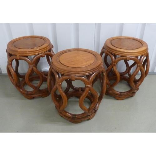 18 - Three oriental barrel shaped hardwood stools with scroll pierced sides on bracket feet, 45 x 43cm ea... 