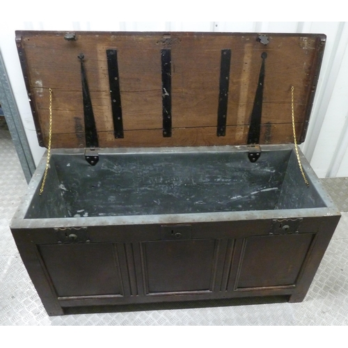 20 - An antique oak lead lined coffer, panelled sides, hinged top on four bracket feet, 66 x 138 x 56cmn