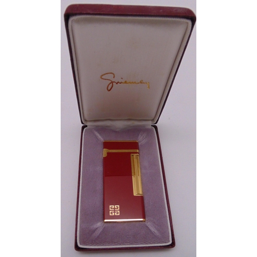 246 - Givenchy 2000 red enamel and gilded cigarette lighter in original packaging