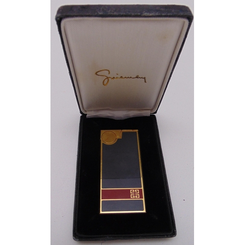 248 - Givenchy enamel and gilded metal cigarette lighter in original packaging