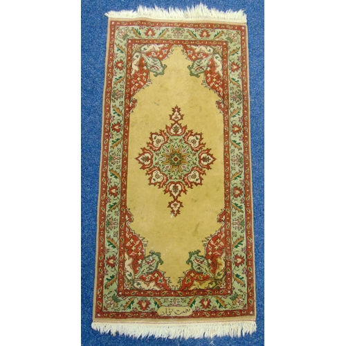 41 - A Middle Eastern rectangular wool carpet, central rosettes within floral border predominately beige ... 