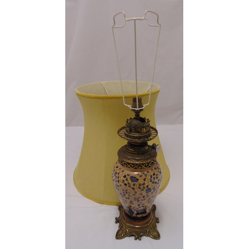 49 - A Victorian oil lamp with baluster ceramic body on raised square base with shell feet, converted to ... 