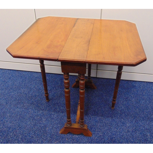 10 - A rectangular mahogany Sutherland table with drop sides and turned cylindrical supports, 58.5 x 64.5... 