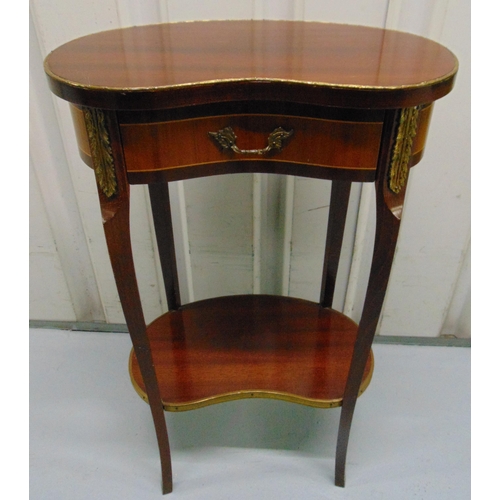 11 - A mahogany kidney shaped side table with gilded metal mounts, a single drawer on four cabriole legs,... 