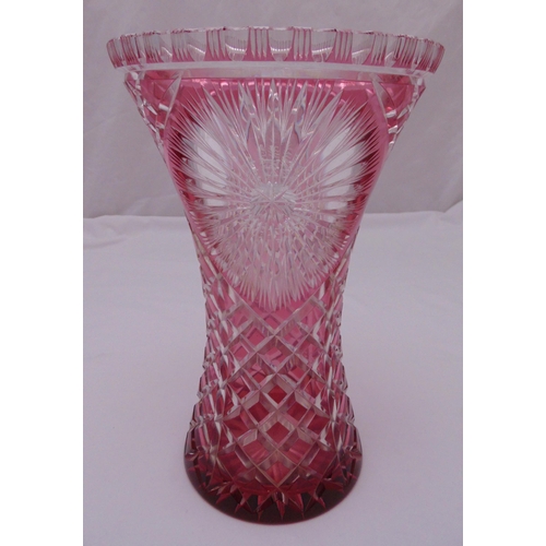 155 - A Bohemian overlaid ruby waisted cylindrical hobnail cut vase, 36.5cm (h)