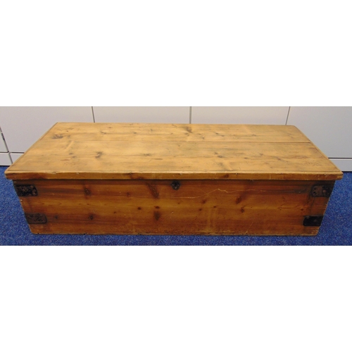 26 - A rectangular pine trunk, metal bound side handles and hinged cover, 120 x 49 x 30cm