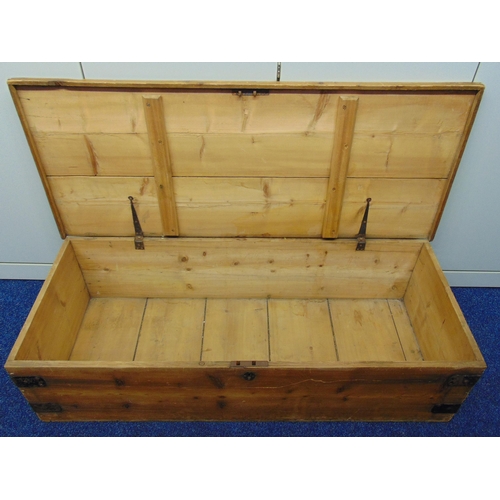 26 - A rectangular pine trunk, metal bound side handles and hinged cover, 120 x 49 x 30cm