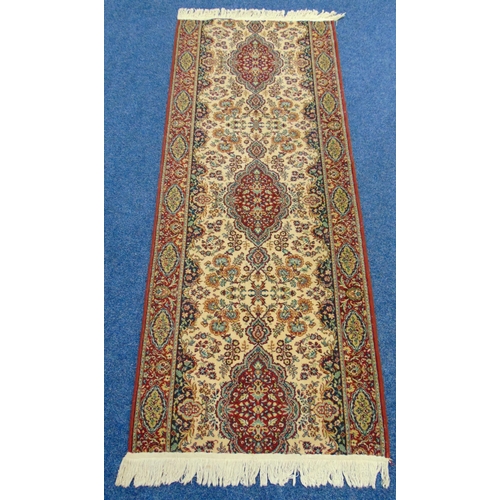 41 - A wool runner, cream ground with repeating pattern and red border, 2.3m x 90cm