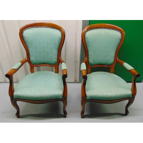 13 - A pair of mahogany upholstered armchairs on scroll legs