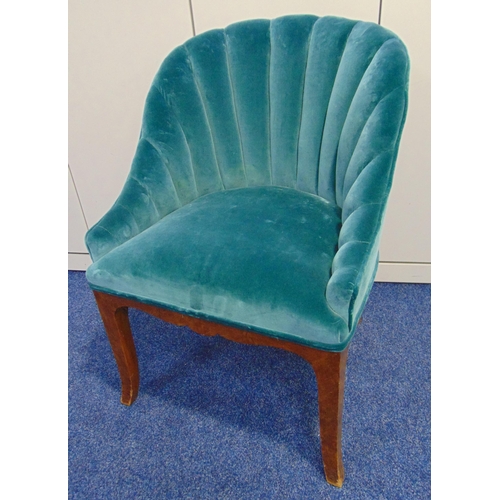 14 - An Art Deco upholstered tub chair with fluted scalloped back on four outswept legs