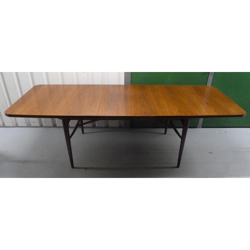 2 - A mid 20th century Rosewood rectangular dining table with one drop in leaf and six matching chairs, ... 