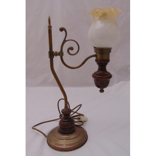 25 - A Victorian style brass and wooden table lamp, the scrolling arm supporting a lamp with fluted frost... 