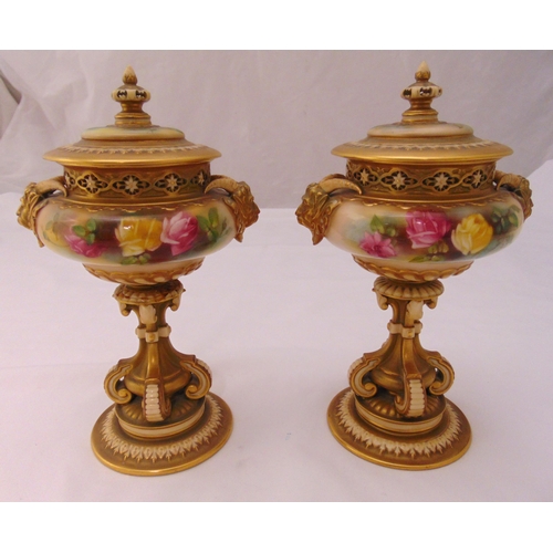 103 - A pair of Royal Worcester pot pourri holders of compressed cylindrical form decorated with flowers, ... 