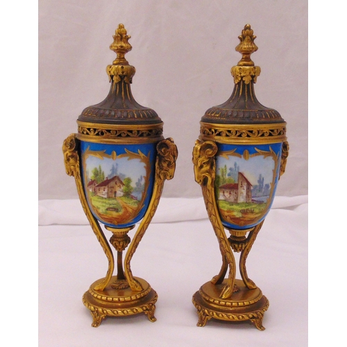 109 - A pair of French Sevres style ormolu and ceramic vases and covers decorated with landscapes on raise... 