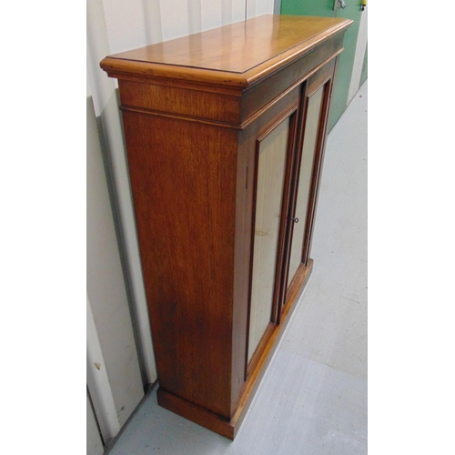 4 - A Regency rectangular cabinet with glazed doors on pedestal base, 106.5 x 89 x 30cm