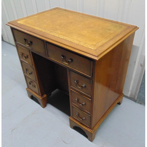 7 - A mahogany rectangular kneehole desk with eight drawers and tooled leather top, 76 x 77.5 x 51cm