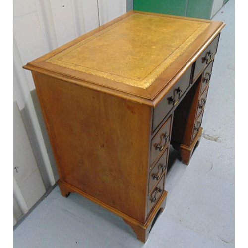 7 - A mahogany rectangular kneehole desk with eight drawers and tooled leather top, 76 x 77.5 x 51cm