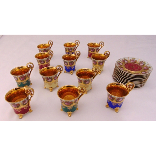 82 - A set of twelve Vienna cabinet cups and saucers decorated with Rococo roundels, the cups on four scr... 