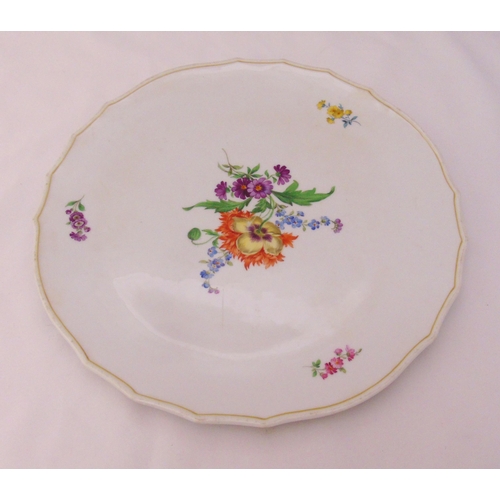 93 - A Meissen cake plate decorated with flowers and leaves, marks to the base, 33.5cm (d)