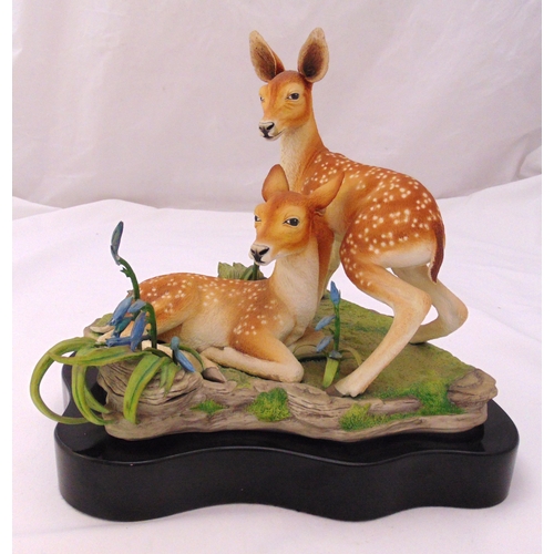 137 - A limited edition ceramic figural group of two deer on a naturalistic base titled Young and Free by ... 