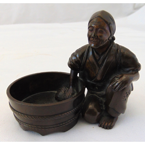 188 - An oriental bronze of a washer woman kneeling by her bowl, 7cm (dia)