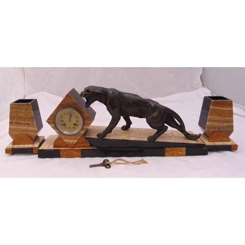 279 - An Art Deco style desk clock, the circular dial with Arabic numerals flanked by a cast bronze Jaguar... 