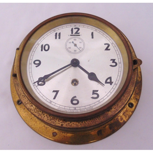 282 - A brass mounted ships clock, silvered dial, subsidiary seconds dial and Arabic numerals, 16cm (dia)