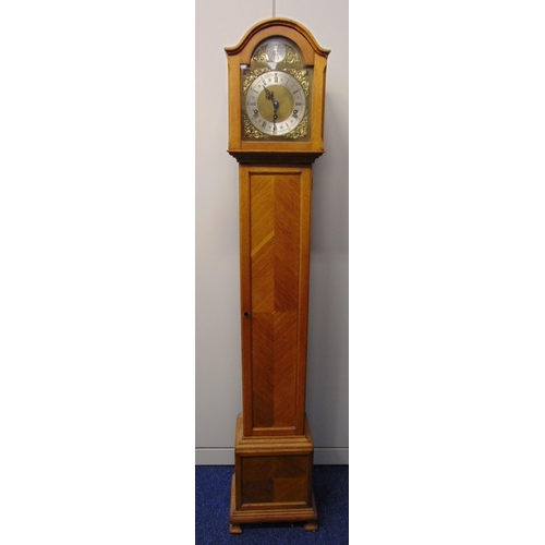 283 - An oak cased grandmother clock the silvered dial with Roman numerals, two train movement, the pedest... 