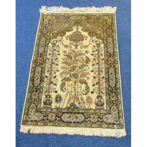 32 - A Persian wool and silk carpet light brown ground with tree of life design and repeating floral bord... 