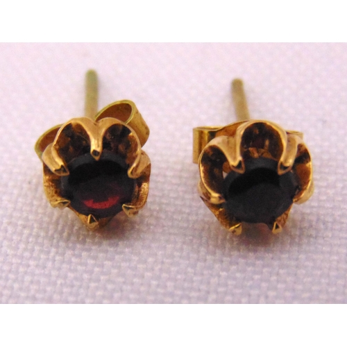 338 - A pair of 9ct gold and garnet earrings