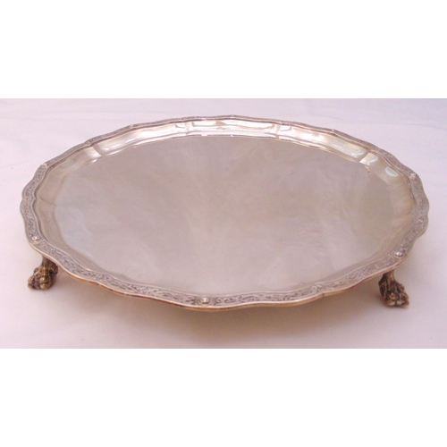 362 - A hallmarked silver salver, circular with Celtic border on four ball and claw feet, London 1931, app... 