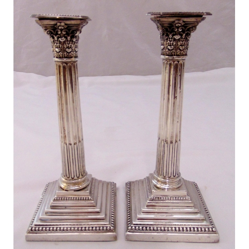 363 - A pair of Victorian hallmarked silver Corinthian column table candlesticks on stepped square bases w... 