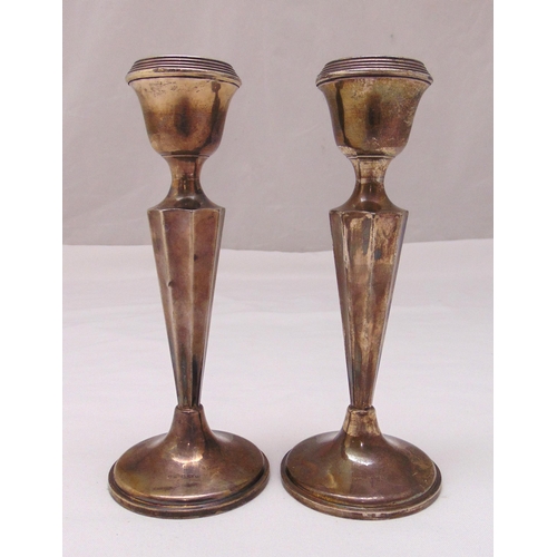 365 - A pair of hallmarked silver table candlesticks, fluted tapering stems on circular spreading bases, B... 