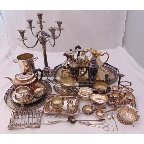 412 - A quantity of silver plate to include trays, a candelabrum, a wine cooler, teapots, jugs and a toast... 