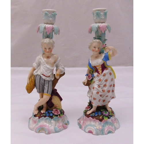 120 - A pair of Augustus Rex figural candlesticks of a boy holding a sheaf of wheat and a girl holding flo... 