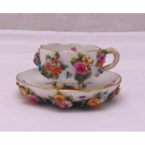 121 - Meissen cabinet cup and saucer with applied flowers and leaves, marks to the bases, slight loss of f... 