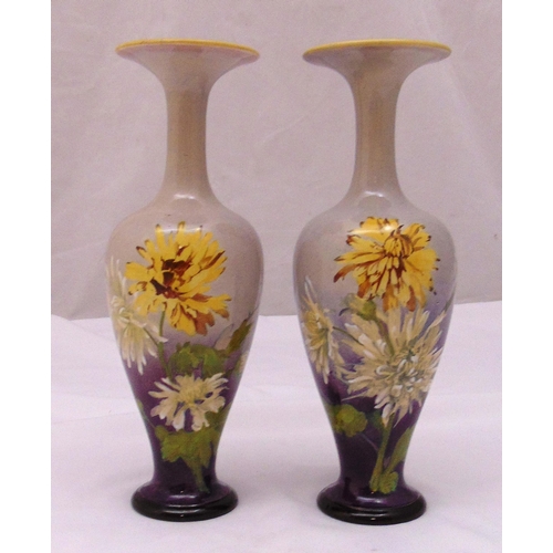 132 - A pair of Doulton baluster vases decorated with flowers and leaves, marks to the bases 23.5cm (h)