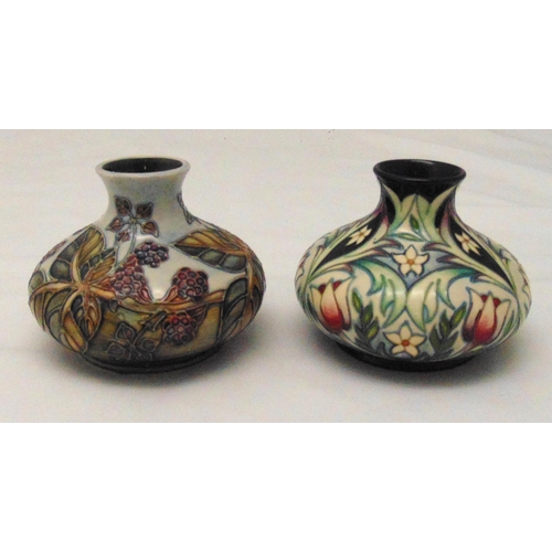 133 - Two Moorcroft squat vases decorated with flowers and leaves, marks to the bases, each 10.5cm (h)