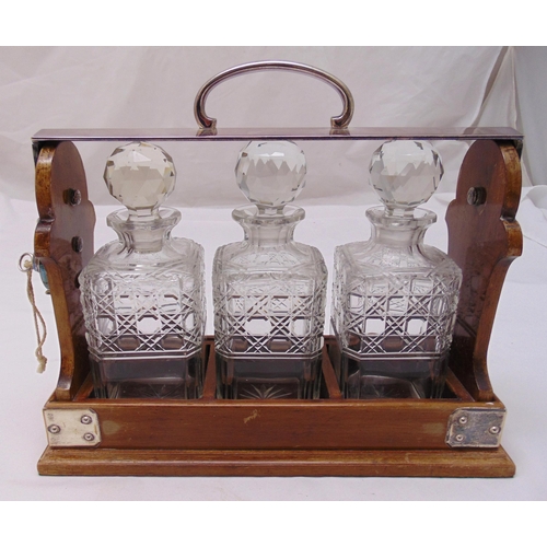 167 - Betjemanns three bottle tantalus of customary form to include key, 29 x 35cm