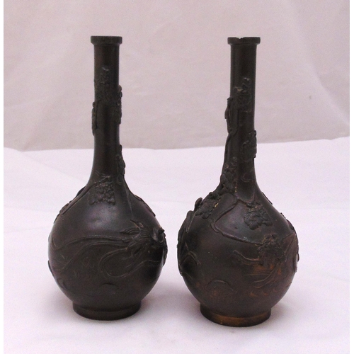 180 - A pair of Oriental bronze vases with applied birds, flowers and leaves, 24cm (h)