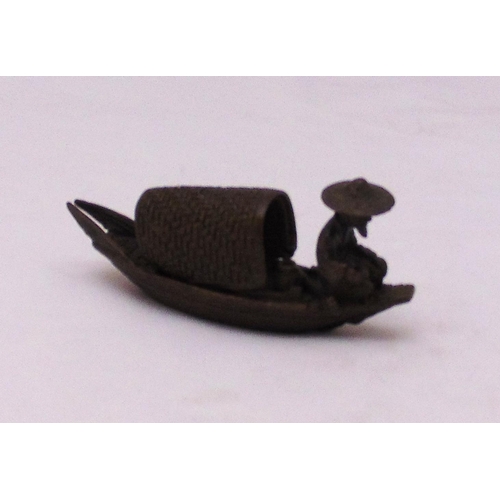 186 - A Japanese Okimono bronze figurine of a fishing boat with fisherman, 10cm (l)