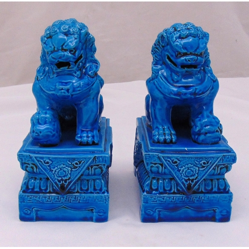 190 - A pair of Chinese turquoise bookends in the form of seated lions on raised rectangular plinths, 21.5... 