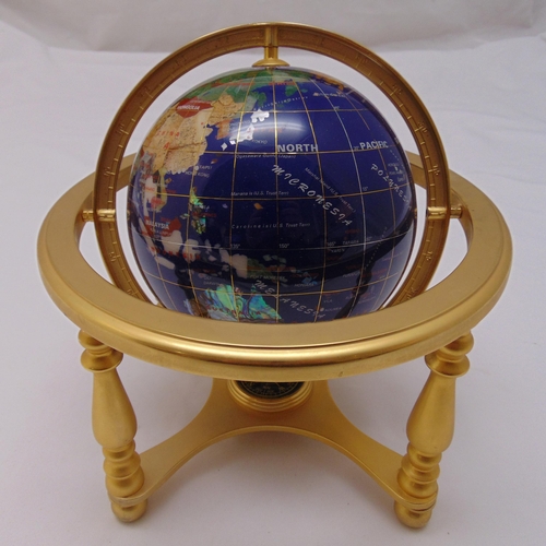 203 - A table top composite globe with compass to the base supported by a brass frame, 25 x 23cm