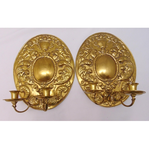 204 - A pair of Victorian brass two branch wall sconces with oval leaf chased back plates, 38 x 30cm