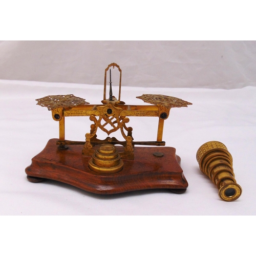 207 - A brass letter scale and weights mounted on a walnut plinth and a miniature seven draw brass telesco... 