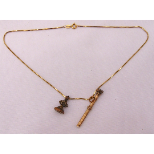 382 - A 9ct gold chain with a miniature propelling pencil pendant and a seal pendant, approx total weight ... 